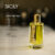 A 120ml bottle of Mancera Sicily Eau de Parfum with a gold cap and yellow liquid on a marble table.