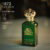A 100ml bottle of Clive Christian 1872 For Men Eau de Parfum with a gold and green design on a marble table