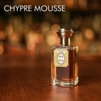 A 100ml bottle of Oriza L. Legrand Chypre Mousse Eau de Parfum with a gold and clear design on a white table