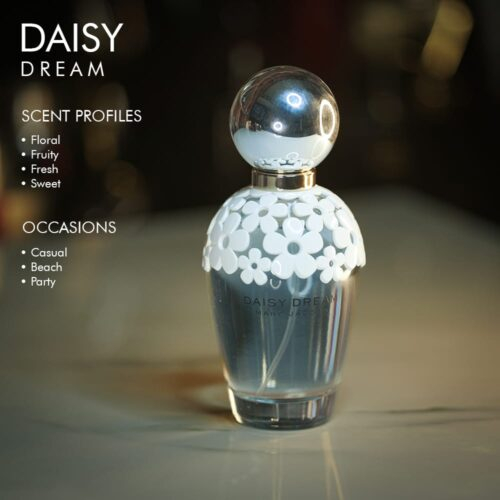 A 100ml bottle of Marc Jacobs Daisy Dream Eau de Toilette with a blue and white design on a marble table