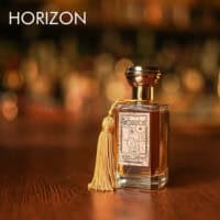 A 100ml bottle of Oriza L. Legrand Horizon Eau de Parfum with a gold and clear design on a white table