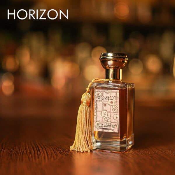 A 100ml bottle of Oriza L. Legrand Horizon Eau de Parfum with a gold and clear design on a white table