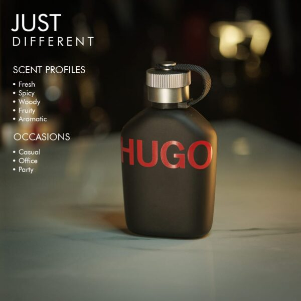 A 100ml bottle of Hugo Boss Just Different Eau de Toilette with a black design and red label on a white table