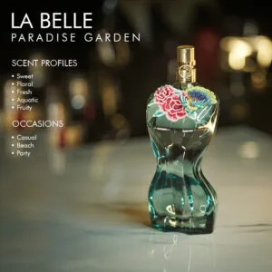 A 100ml bottle of Jean Paul Gaultier La Belle Paradise Garden Eau de Parfum with a green and gold design on a marble table