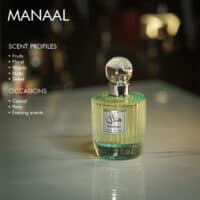 A 100ml bottle of Paris Corner Manaal Eau de Parfum with a clear cap and green design on a marble table