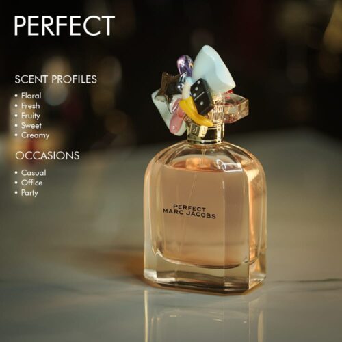 A 100ml bottle of Marc Jacobs Perfect Eau de Parfum with a clear and pink gold design on a marble table