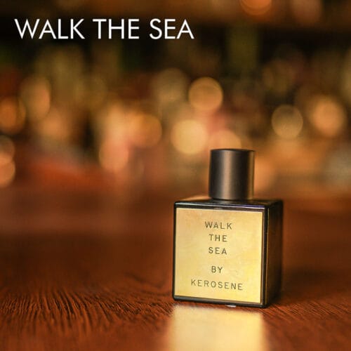 A 100ml bottle of Kerosene Walk The Sea Eau de Parfum with a black and gold design on a white table