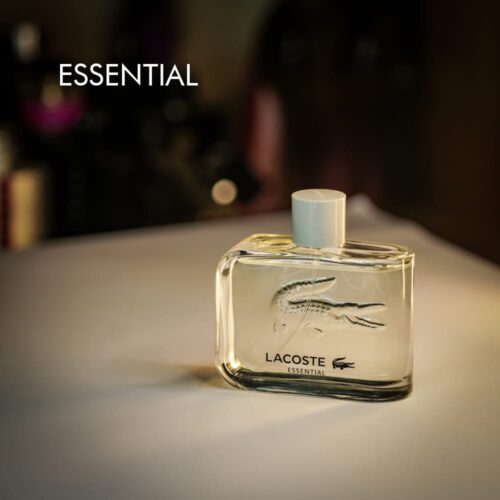 A 100ml bottle of Lacoste Lacoste Essential Eau de Toilette with a clear design with white cap on a white table