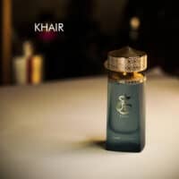 A 100ml bottle of Paris Corner Khair Eau de Parfum with a gold and green design on a white table