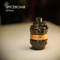 A 100ml bottle of Viktor&Rolf Spicebomb Extreme Eau de Parfum with a grenade-shaped black and gold design on a white table