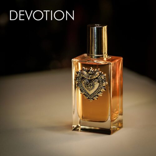 A 100ml bottle of Dolce & Gabbana Devotion Eau de Parfum with a luxurious gold design on a white table