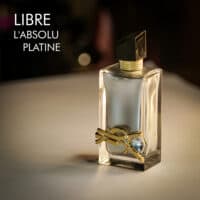 A 100ml bottle of Yves Saint Laurent Libre L’Absolu Platine Eau de Parfum with a silver design and black cap on a white table