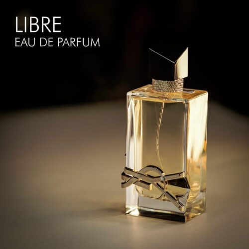 A 100ml bottle of Yves Saint Laurent Libre Eau de Parfum with a clear design and a gold label on a white table