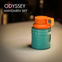 A 100ml bottle of Armaf Odyssey Mandarin Sky Eau de Parfum with an orange and green design on a white table