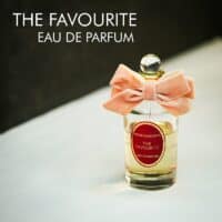 A clear bottle with a pink bow tie of Penhaligon's The Favourite Eau de Parfum with gold font labels.