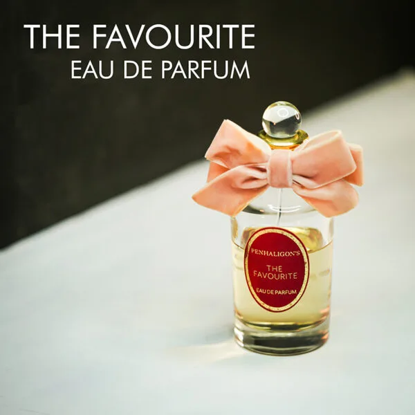 A clear bottle with a pink bow tie of Penhaligon's The Favourite Eau de Parfum with gold font labels.