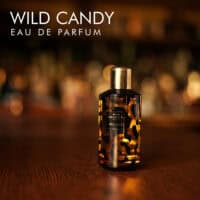 A 100ml bottle of Mancera Wild Candy Eau de Parfum with a black and gold design on a white table