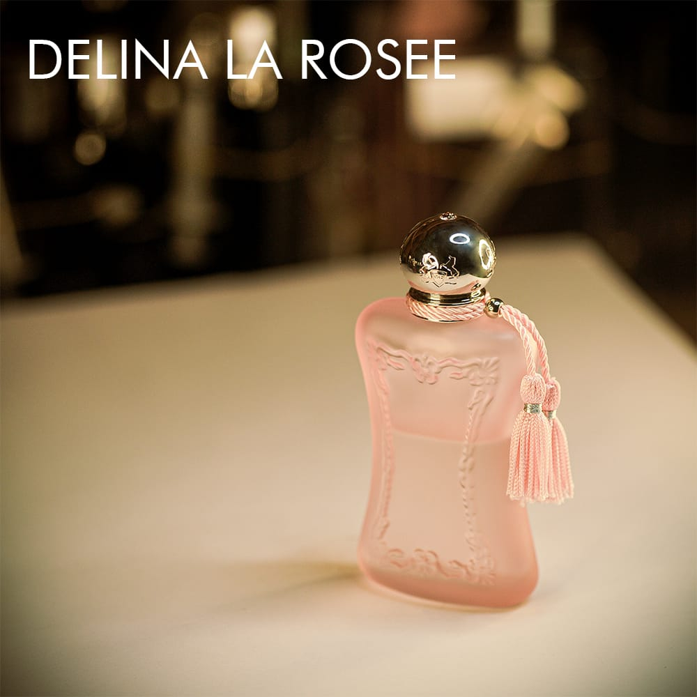 A 100ml bottle of Parfums de Marly Delina La Rosée Eau de Parfum with a soft pink design on a white table