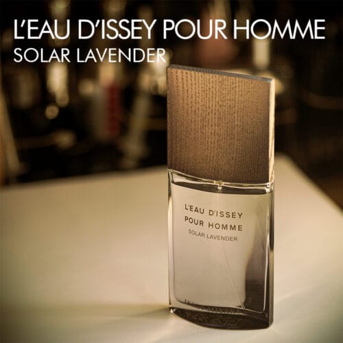 A 100ml bottle of Issey Miyake L’Eau d’Issey pour Homme Solar Lavender Eau de Parfum with a clear design and lavender-colored liquid with a white label on a white table