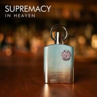 supremacy in heaven A 100ml bottle of Afnan Supremacy in Heaven Eau de Parfum with a sleek blue and silver design on a brown table