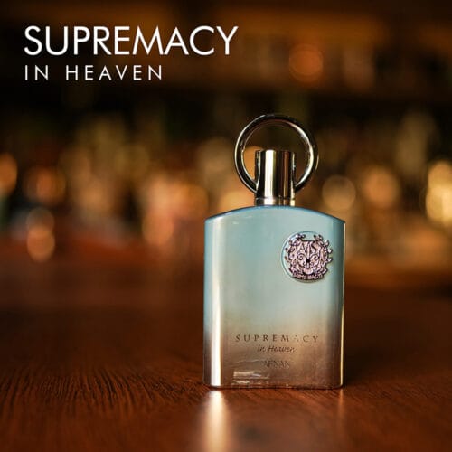 A 100ml bottle of Afnan Supremacy in Heaven Eau de Parfum with a sleek blue and silver design on a brown table