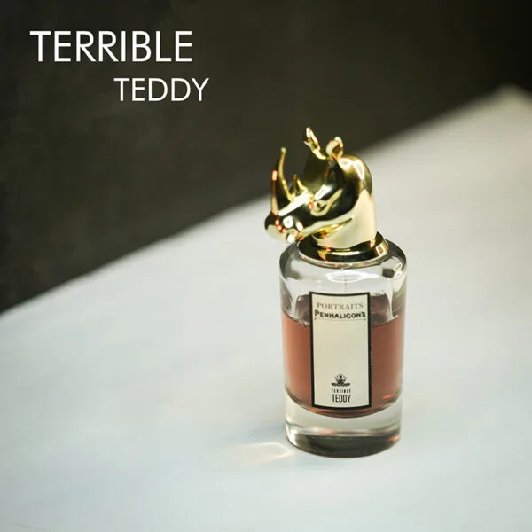 A clear bottle with amber liquid and a gold rhino-head cap of Penhaligon's Terrible Teddy Eau de Parfum with black font labels.