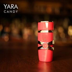 A 100ml bottle of Lattafa Yara Candy Eau de Parfum with a playful pink design on a brown table