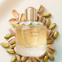 30 Luxurious perfume bottle with pistachio nuts, emphasizing natural ingredients and elegant scent.