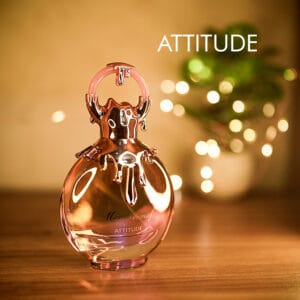 A 100ml bottle of Miss Armaf Attitude Eau de Parfum with a gold cap on a brown table.