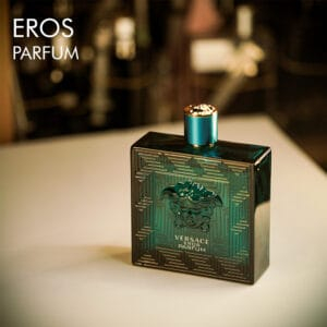 A 100ml bottle of Versace Eros Parfum with a vibrant green design with golden label on a white table