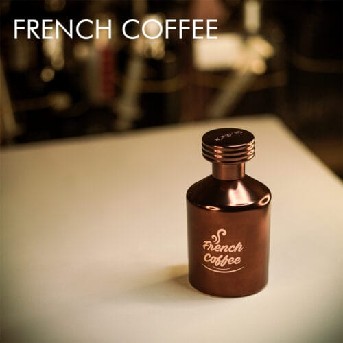 A 100ml bottle of Al Rehab French Coffee Eau de Parfum with a warm brown and gold design on a white table