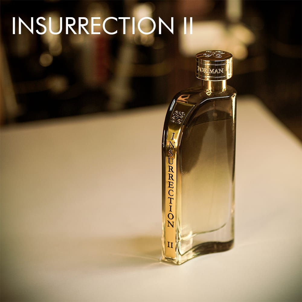 A 100ml bottle of Reyane Tradition Insurrection II Wild Eau de Toilette in a tinted green-golden bottle on a white table