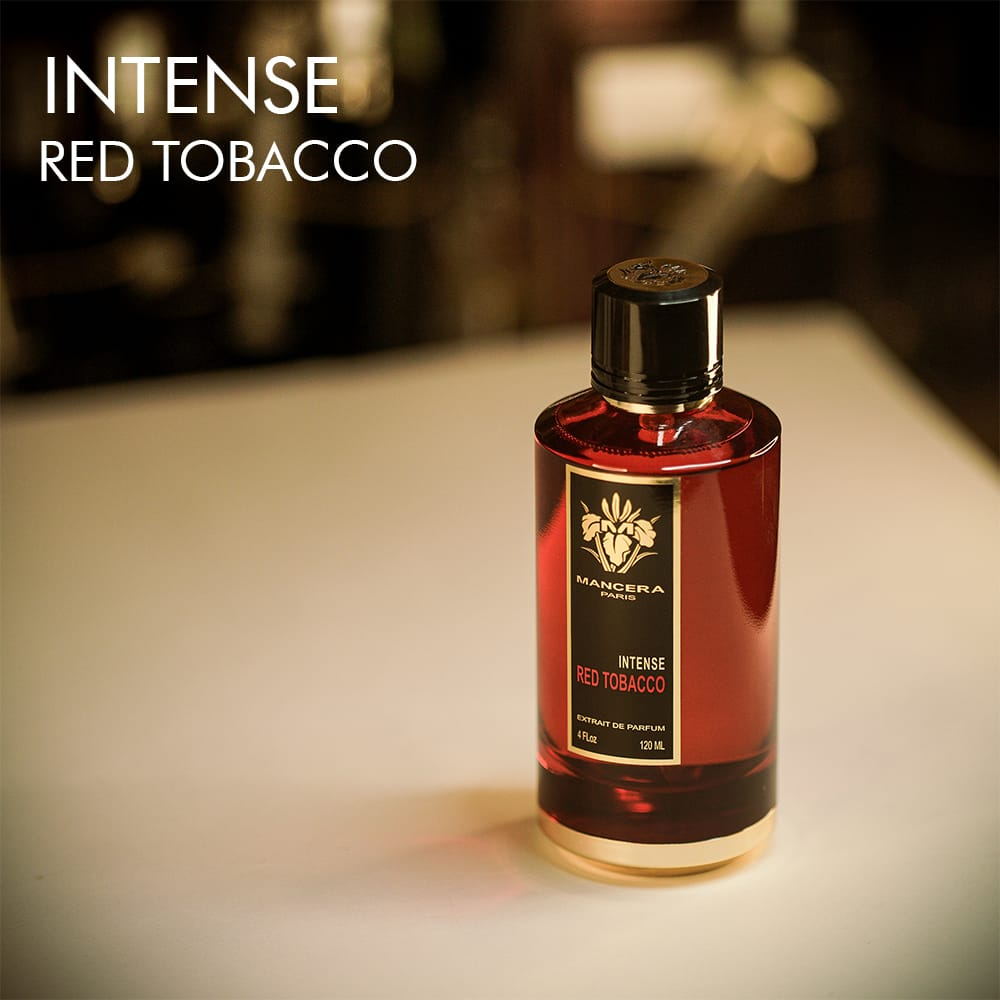 A 120ml bottle of Mancera Red Tobacco Intense Eau de Parfum with a bold red and gold design on a white table