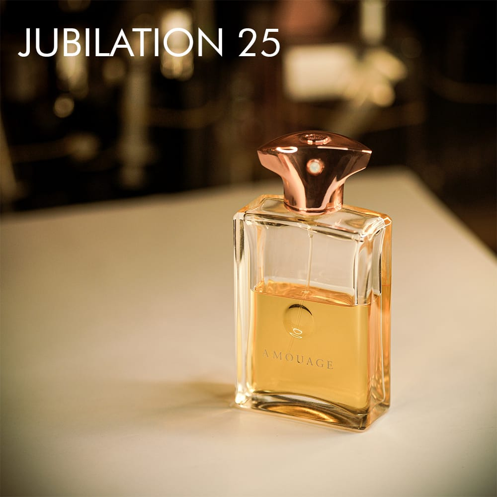 A 100ml bottle of Amouage Jubilation XXV Eau de Parfum with an opulent gold design on a white table