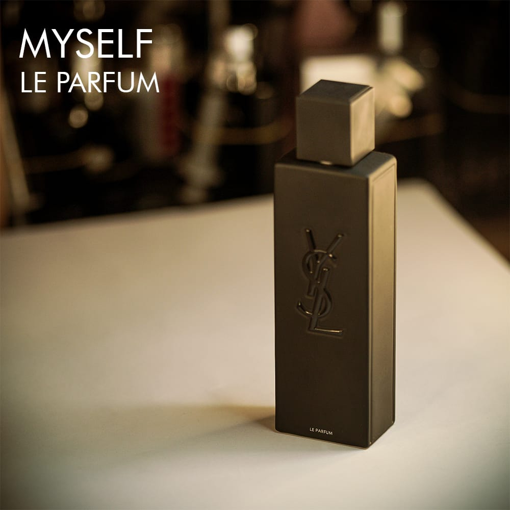 A 100ml bottle of Yves Saint Laurent Myslf Le Parfum with a minimalist black design with white label on a white table