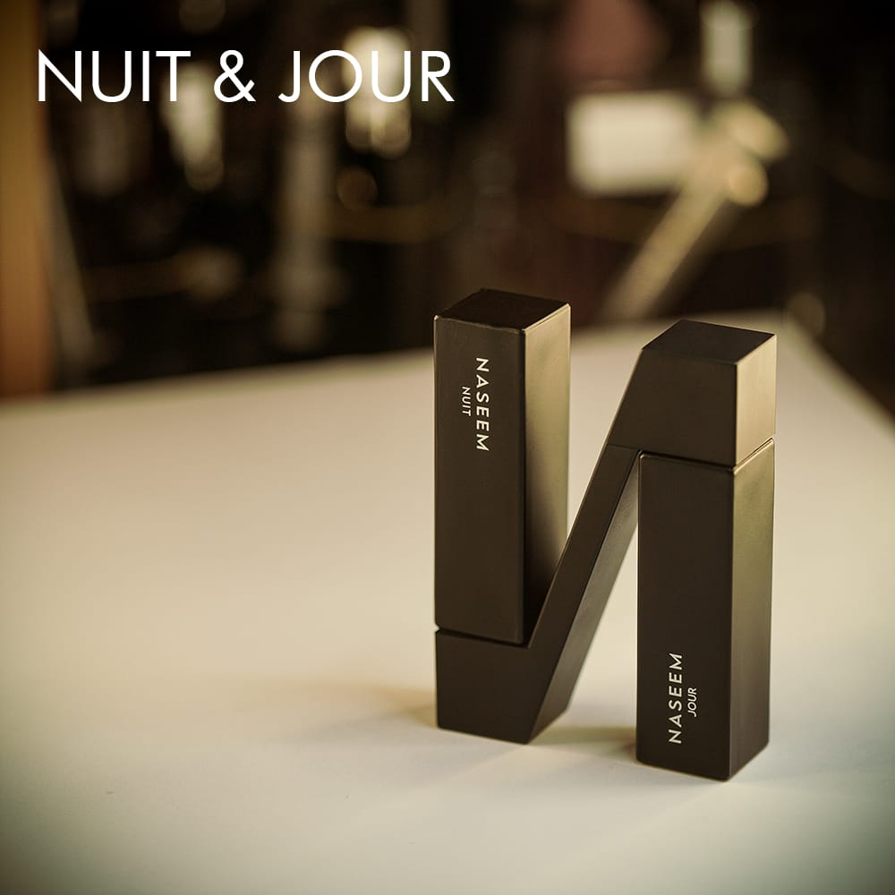 A 100ml bottle of Naseem Nuit & Jour Eau de Parfum in black, N shaped dual bottles on a white table