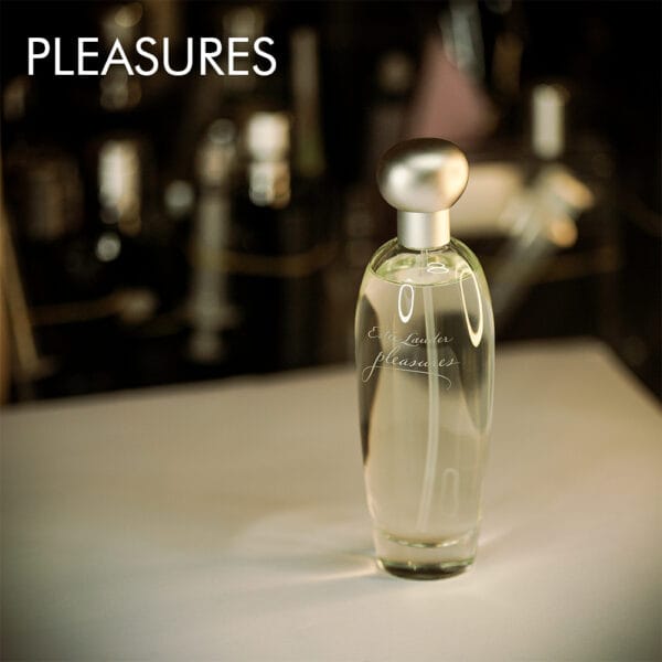 A 100ml bottle of Estée Lauder Pleasures Eau de Parfum in a transparent bottle, silver cap on a white table