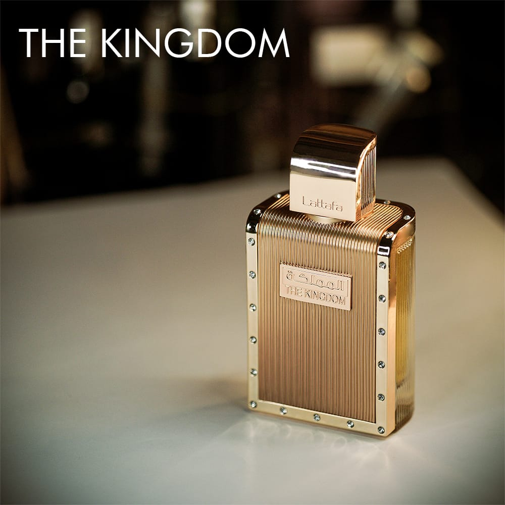 A 100ml bottle of Lattafa The Kingdom For Men Eau de Parfum in a golden bottle on a white table