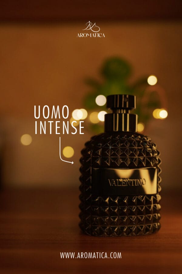 A 100ml bottle of Valentino Uomo Intense Eau de Parfum with a black cap on a brown table.