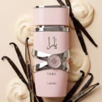 Elegant pink perfume bottle surrounded by vanilla beans and creamy swirls, emphasizing luxurious fragrance and natural ingredients.