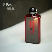 A red tinted bottle of Afnan 9 PM Rebel Eau De Parfum with red & black font labels.