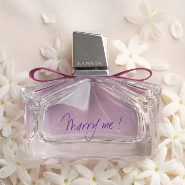 Luxurious Lanvin Marry Me perfume bottle with white flowers background, floral fragrance, romantic gift.