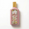 Soft pink Gucci Flora decorative bottle with floral design, luxurious scent for women.