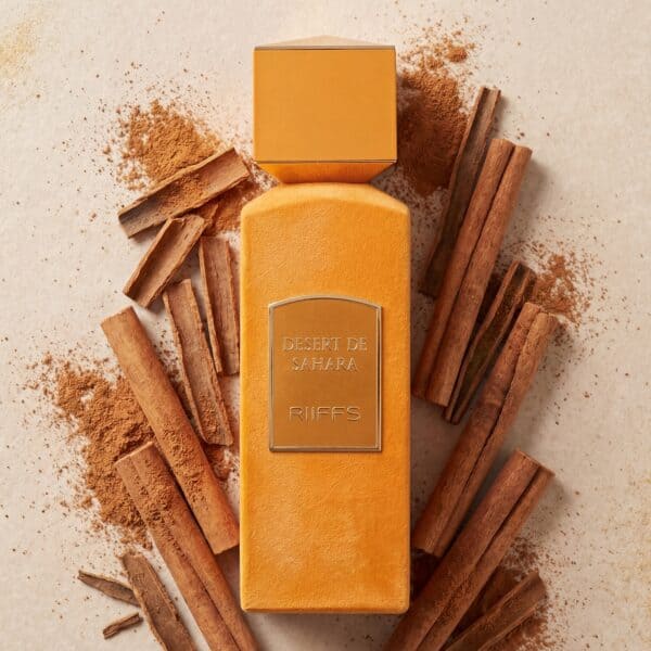 Singles (4) Warm cinnamon and desert-inspired perfume bottle with cinnamon sticks for aromatic elegance.